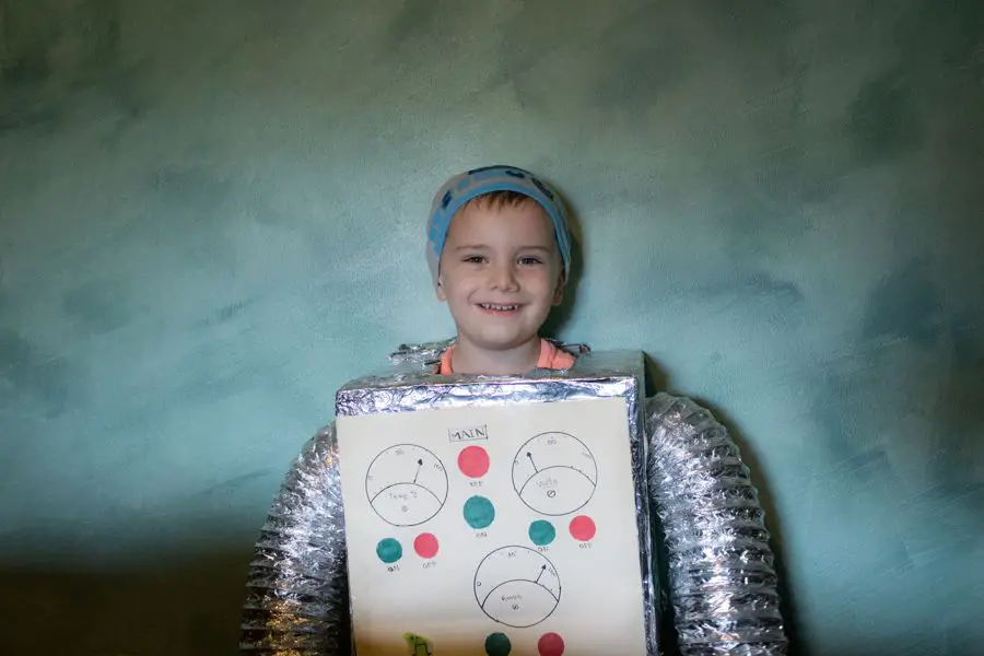 young boy in carboard and foil robot costume