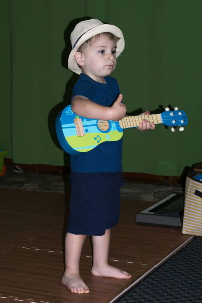 Young boy playing a ukulele