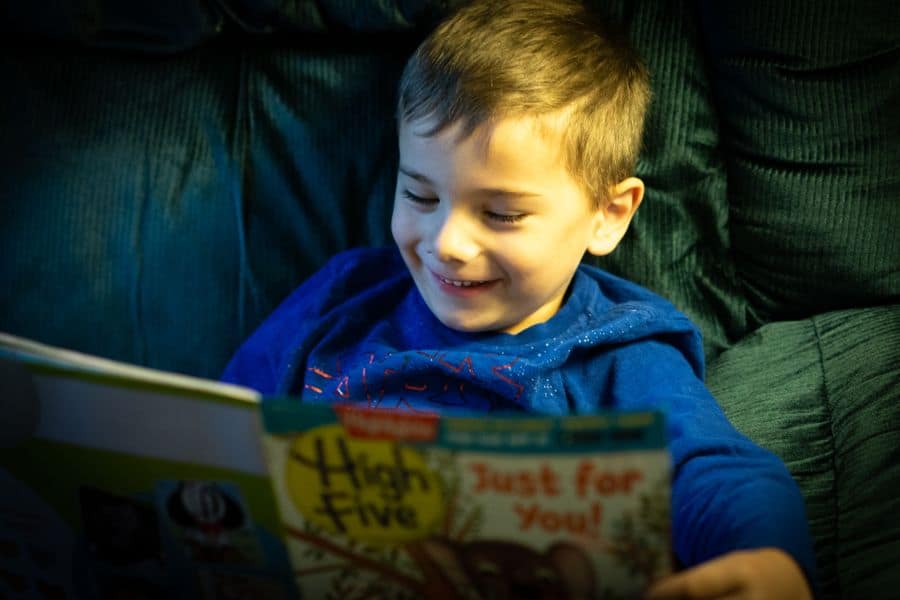 happy young boy reading