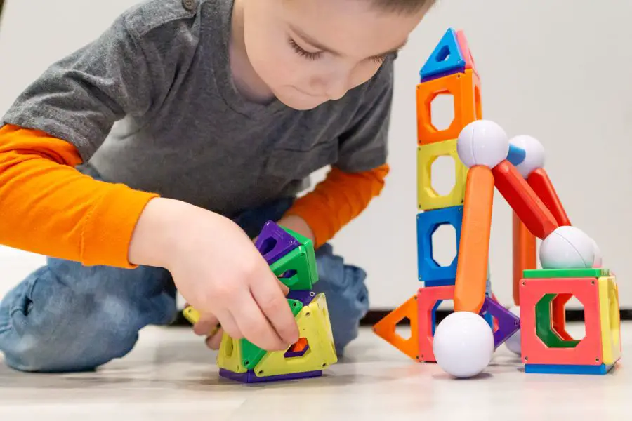 Boy playing with Magna Tiles STEM toy