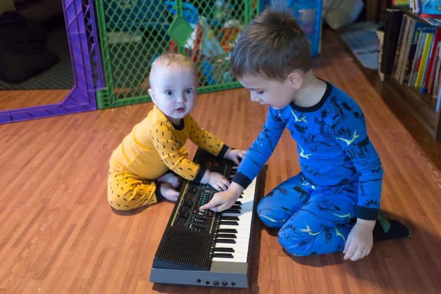 boys playing electronic piano keyboard