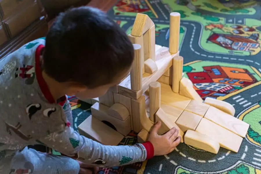 Young Child playing with Wooden Building Blocks