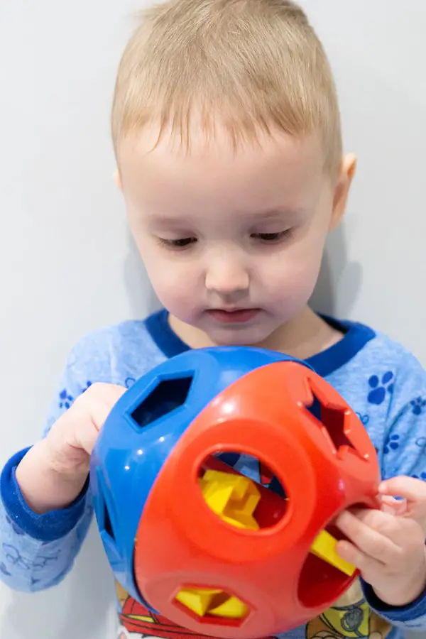 Boy playing with Shape Sorter Toy