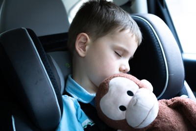 child with stuffed monkey curious george