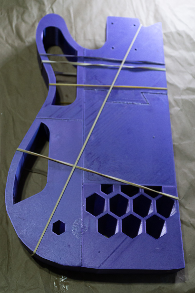 3D printed guitar guing the pieces